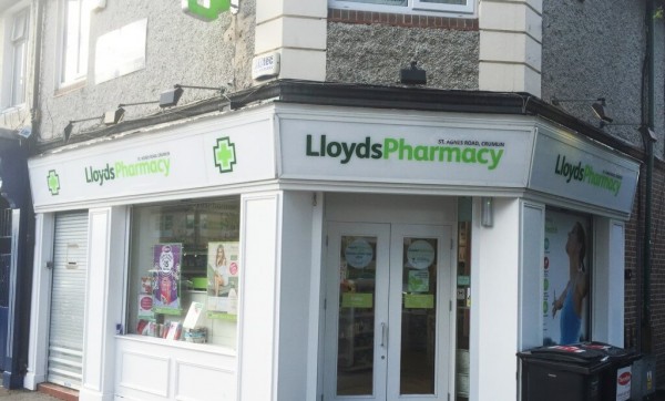 A Lloyds Pharmacy Fascia Sign displayed at a corner in Crumlin town